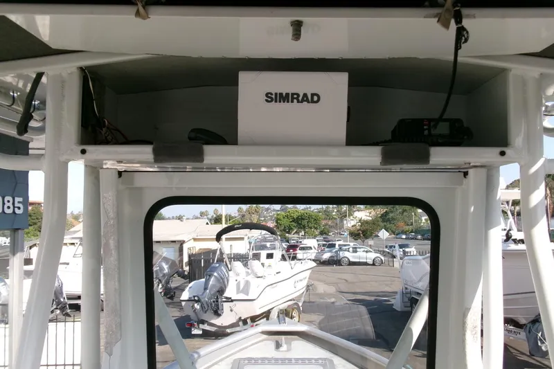 Slide: The Image of Interior view of a 2003 Pacific Boats 2025 V, featuring a Simrad navigation system. - 12