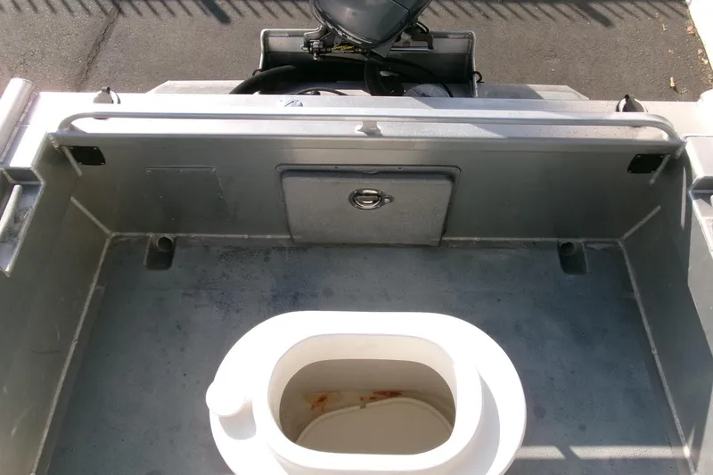 Slide: The Image of 2003 Pacific Boats 2025 V interior with storage compartment and engine view. - 15