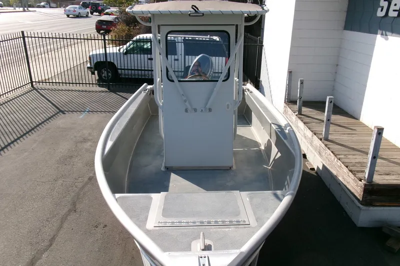 Slide: The Image of 2003 Pacific Boats 2025 V, docked, showcasing spacious deck and cabin. - 17