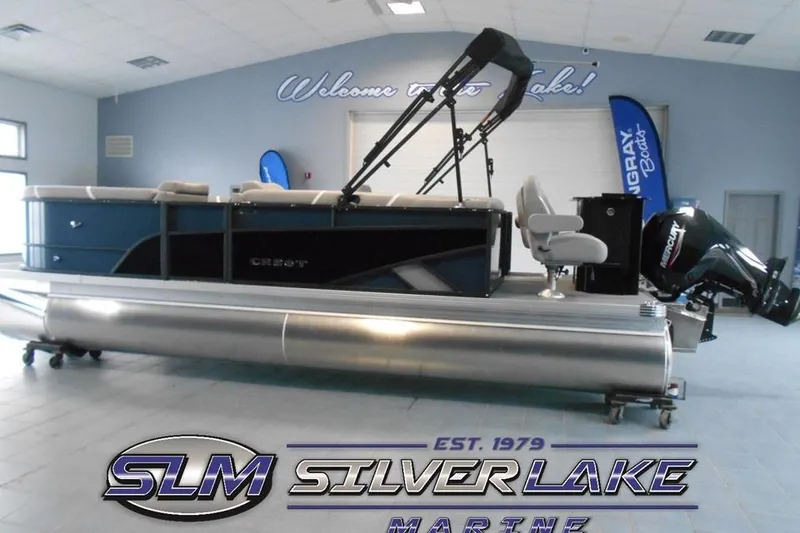 The Image of 2025 Crest Classic Fish 220 pontoon boat displayed indoors at Silver Lake Marine showroom. - 0