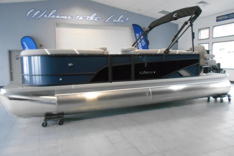 Slide: The Image of 2025 Crest Classic Fish 220 pontoon boat displayed indoors. - 1