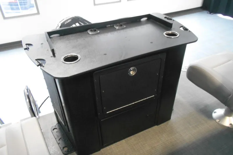 Slide: The Image of 2025 Crest Classic Fish 220 boat console with storage and cup holders. - 10