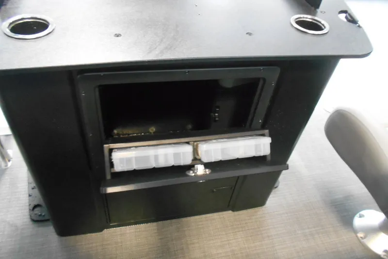 Slide: The Image of Storage compartment on a 2025 Crest Classic Fish 220 boat with cup holders. - 11