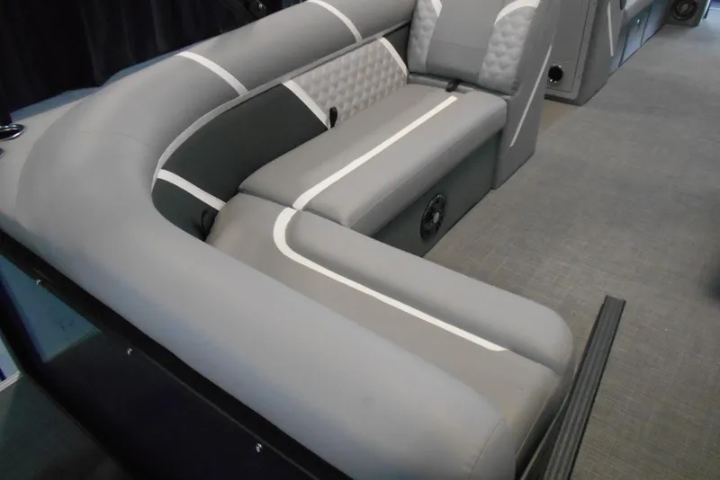 Slide: The Image of 2025 Crest Classic Fish 220 boat interior with gray cushioned seating and modern design. - 15