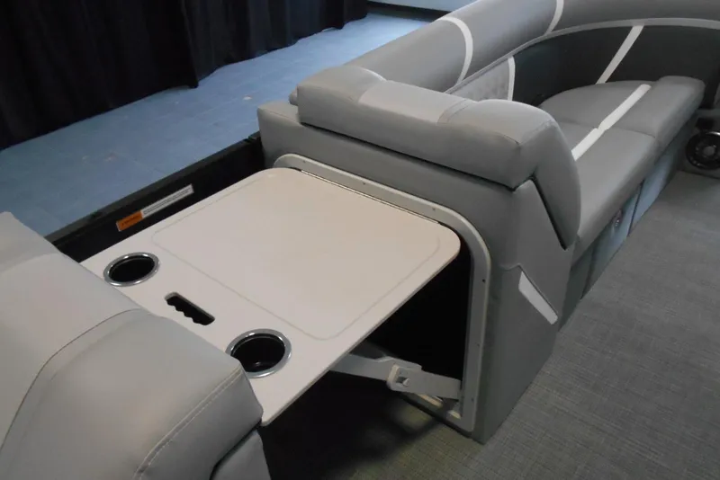 Slide: The Image of 2025 Crest Classic Fish 220 boat interior with foldable table and cup holders. - 18