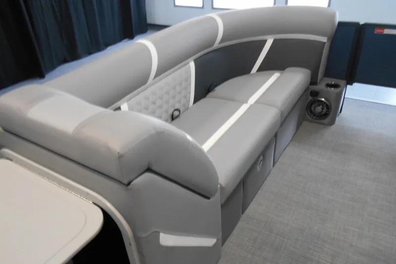 Slide: The Image of 2025 Crest Classic Fish 220 boat interior with gray seating and built-in speaker. - 19