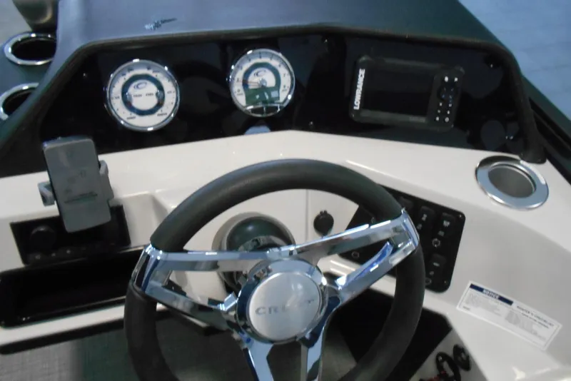 Slide: The Image of Steering console of 2025 Crest Classic Fish 220 boat with gauges and controls. - 20