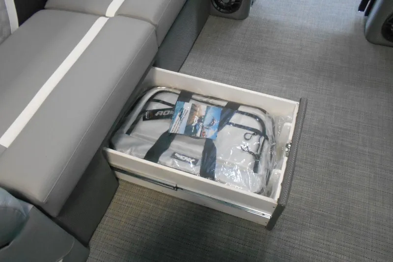 Slide: The Image of Storage compartment in 2025 Crest Classic Fish 220 boat with gray seating and accessories. - 22