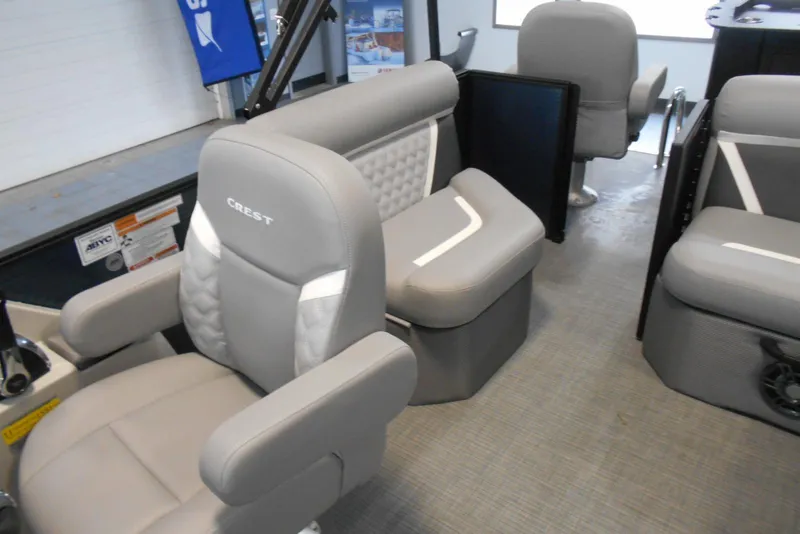 Slide: The Image of 2025 Crest Classic Fish 220 interior with gray seating and modern design. - 26
