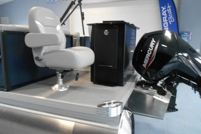 Slide: The Image of 2025 Crest Classic Fish 220 boat interior with Mercury engine and seating. - 5