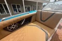 Slide: The Image of 2017 Tigé RZX2 boat interior with tan seating and speaker system. - 12