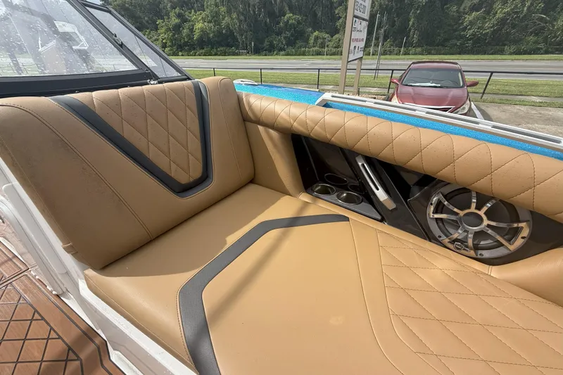 Slide: The Image of 2017 Tigé RZX2 boat interior with tan quilted seats and speaker system. - 35