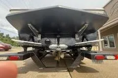 Slide: The Image of 2017 Tigé RZX2 boat rear view, showcasing hull and trailer details. - 4