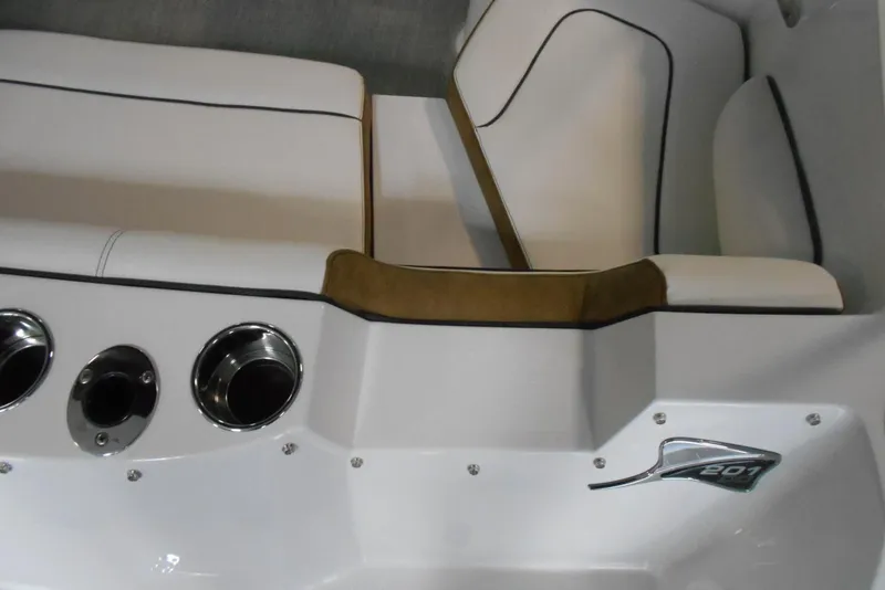 Slide: The Image of 2025 Stingray 201 DC boat interior with white seating and stainless steel cup holders. - 10