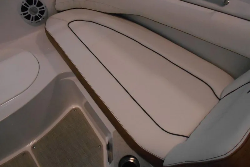 Slide: The Image of 2025 Stingray 201 DC boat interior with cushioned seating and speaker detail. - 12
