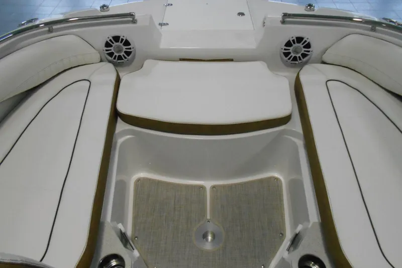 Slide: The Image of 2025 Stingray 201 DC boat interior with white cushioned seating and speakers. - 13
