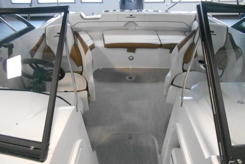 Slide: The Image of 2025 Stingray 201 DC boat interior with seating and steering wheel. - 15