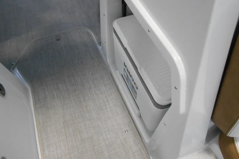 Slide: The Image of 2025 Stingray 201 DC boat interior with built-in cooler storage. - 16