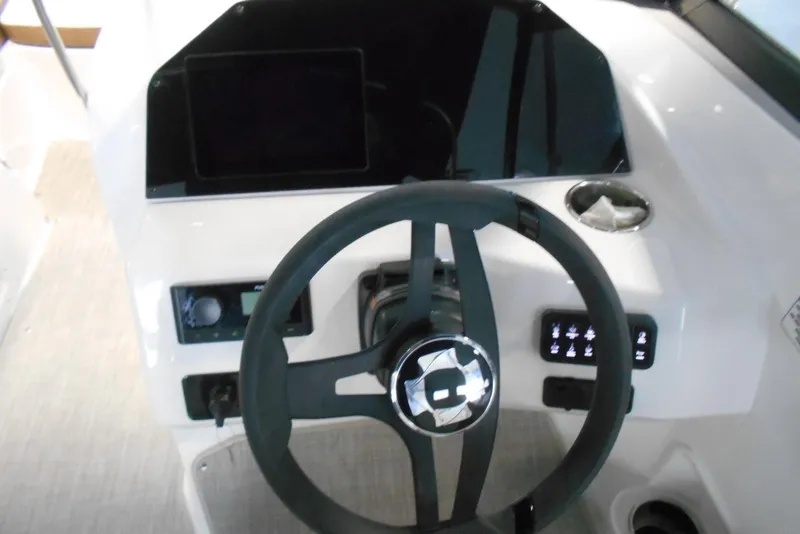 Slide: The Image of Steering console of 2025 Stingray 201 DC boat with modern controls and dashboard. - 21