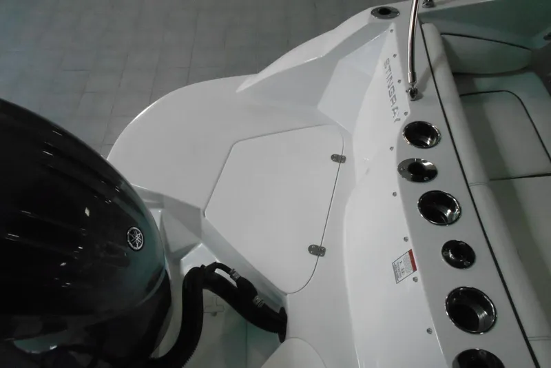 Slide: The Image of 2025 Stingray 201 DC boat deck with Yamaha engine and cup holders. - 6
