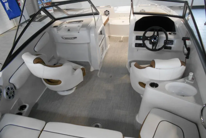 Slide: The Image of 2025 Stingray 201 DC boat interior with modern seating and steering console. - 7