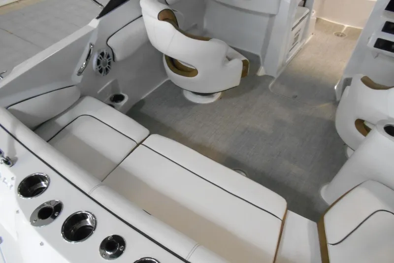 Slide: The Image of Interior of 2025 Stingray 201 DC boat with white seating and cup holders. - 8