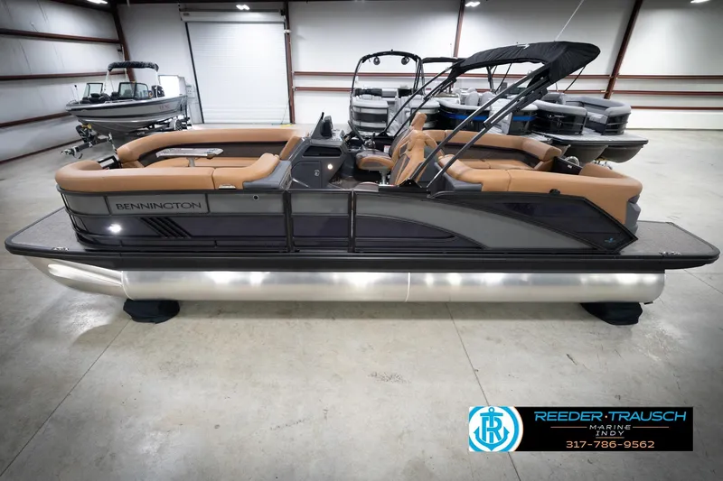The Image of 2026 Bennington 22 MFB pontoon boat with tan seating in a showroom. - 0