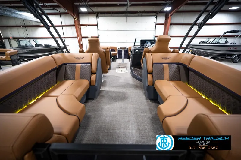 Slide: The Image of 2026 Bennington 22 MFB boat interior with tan seating and ambient lighting. - 18