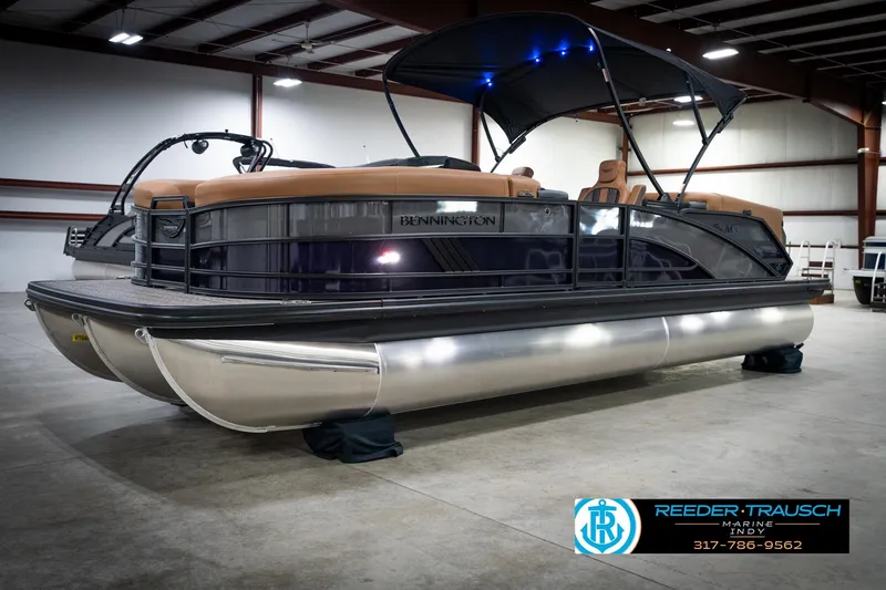 Slide: The Image of 2026 Bennington 22 MFB pontoon boat in showroom, featuring sleek design and modern amenities. - 3