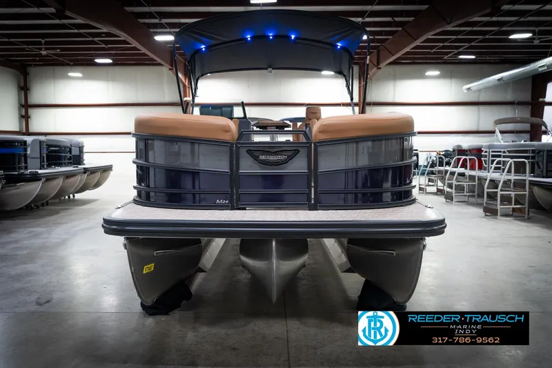 Slide: The Image of 2026 Bennington 22 MFB pontoon boat in showroom with canopy and seating. - 4