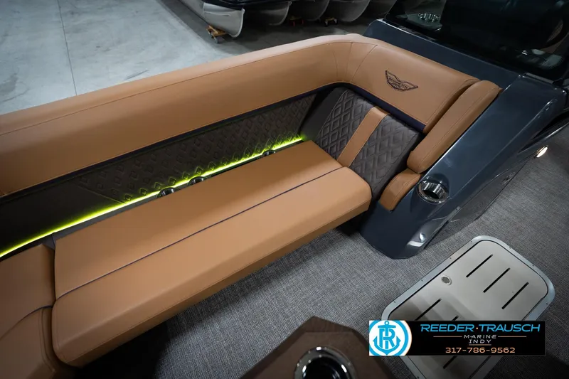 Slide: The Image of Bennington 22 MFB 2026 logo on tan leather seat, Reeder-Trausch Marine contact details. - 44