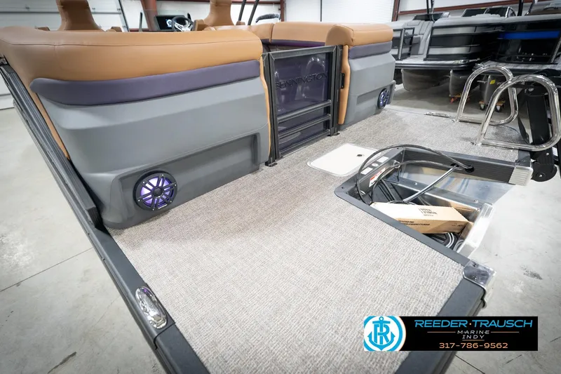 Slide: The Image of 2026 Bennington 22 MFB boat interior with storage compartment and speaker. - 58