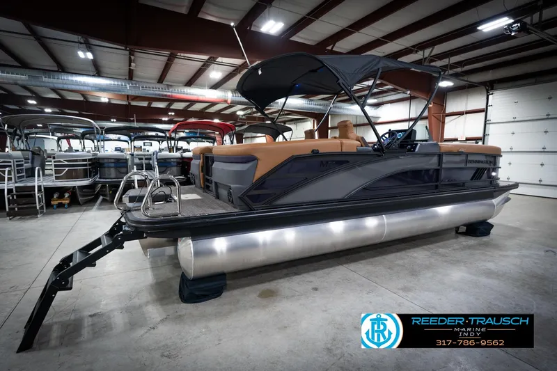 Slide: The Image of 2026 Bennington 22 MFB pontoon boat in a spacious indoor showroom. - 7