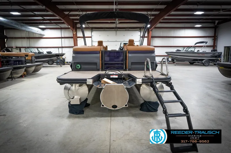 Slide: The Image of 2026 Bennington 22 MFB pontoon boat in showroom with canopy and sleek design. - 8