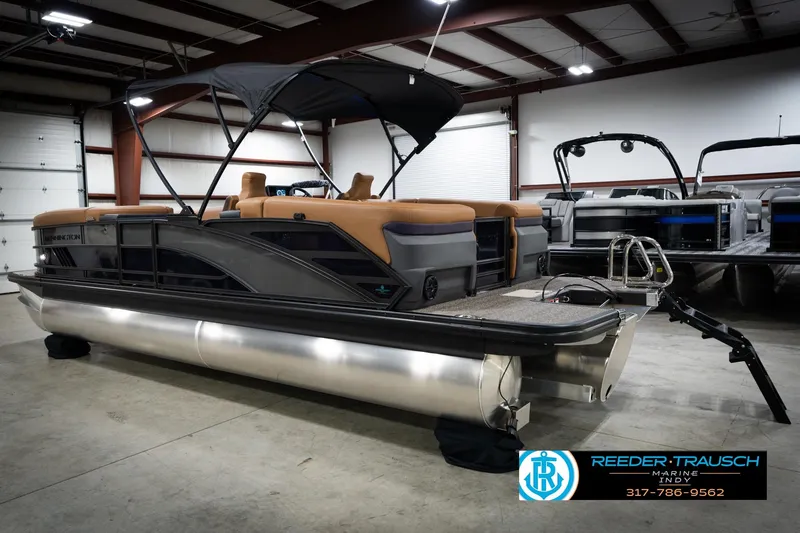 Slide: The Image of 2026 Bennington 22 MFB pontoon boat in showroom, rear view with seating and ladder. - 9