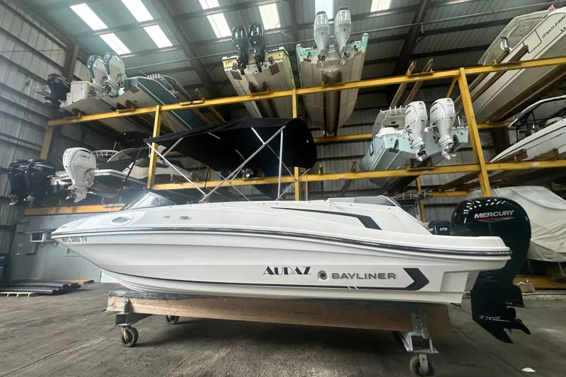 Slide: The Image of 2024 Bayliner VR6 Bowrider OB in storage, featuring a sleek design and Mercury outboard engine. - 1