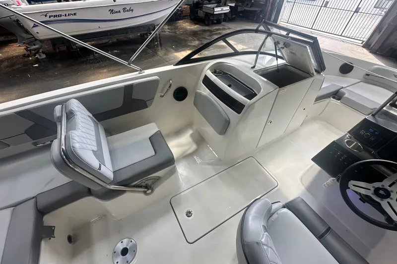 Slide: The Image of 2024 Bayliner VR6 Bowrider OB interior with modern seating and control panel. - 13