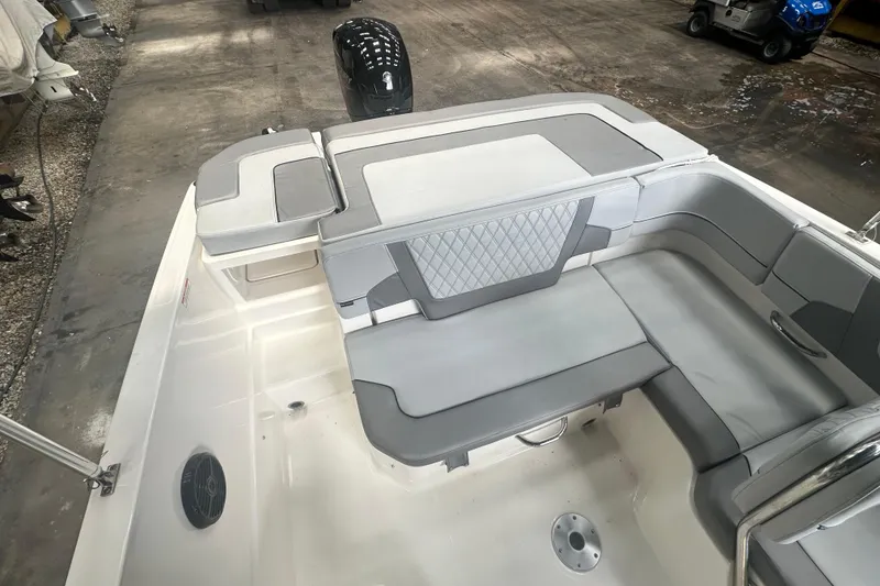 Slide: The Image of 2024 Bayliner VR6 Bowrider OB interior with gray seating and spacious layout. - 14