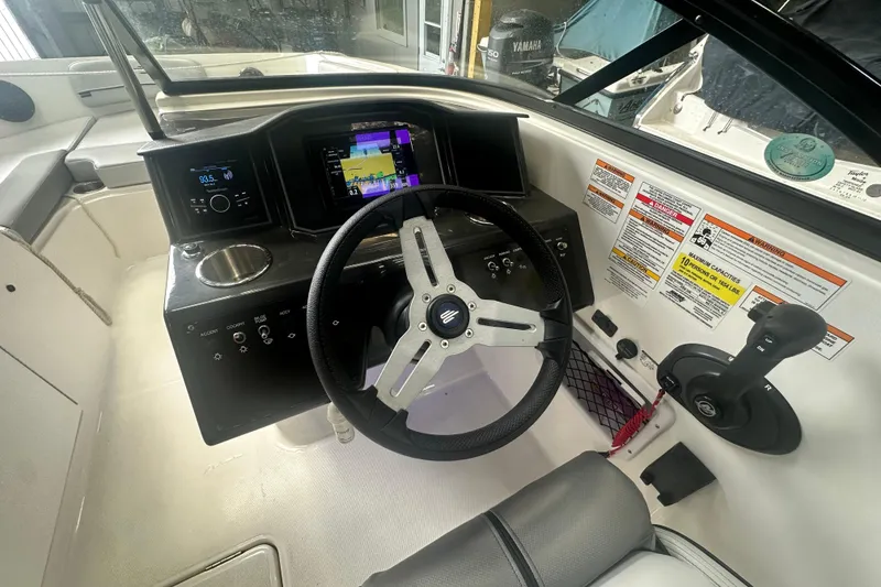 Slide: The Image of 2024 Bayliner VR6 Bowrider OB dashboard with steering wheel and control panel. - 16