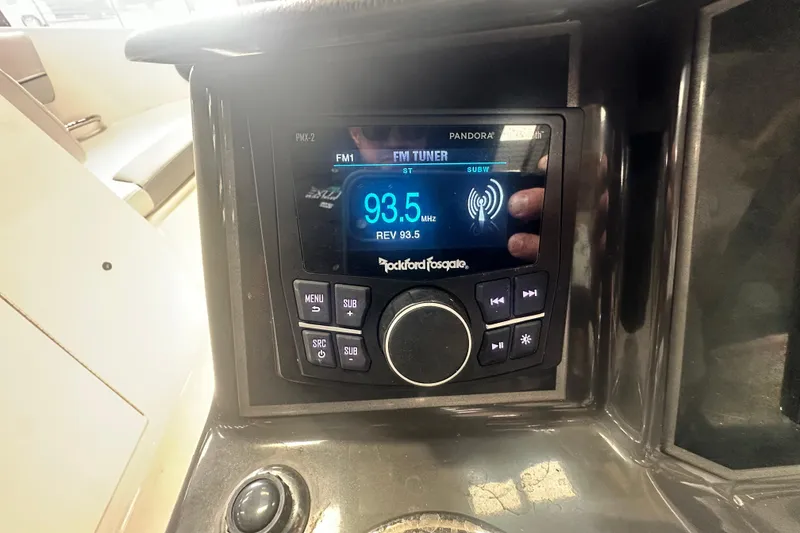 Slide: The Image of 2024 Bayliner VR6 Bowrider OB dashboard with Rockford Fosgate audio system displaying FM tuner. - 20