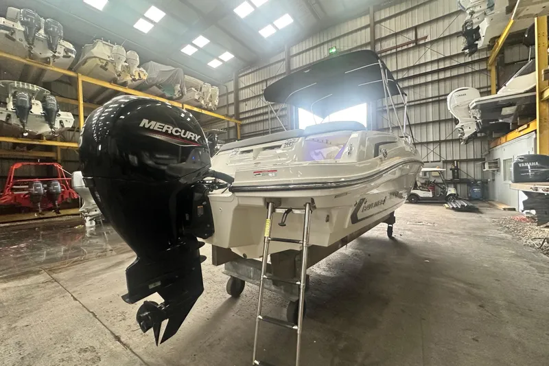 Slide: The Image of 2024 Bayliner VR6 Bowrider OB with Mercury engine in a storage facility. - 3