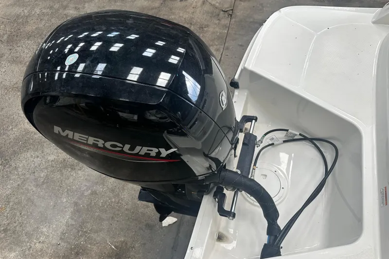 Slide: The Image of 2024 Bayliner VR6 Bowrider OB with Mercury outboard motor, docked on concrete surface. - 4