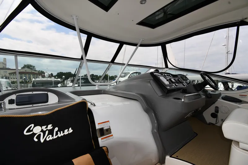 Slide: The Image of 2007 Cruisers Yachts 455 Express Motoryacht helm with modern controls and panoramic windows. - 10
