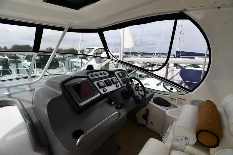 Slide: The Image of 2007 Cruisers Yachts 455 Express Motoryacht helm with modern controls and marina view. - 11
