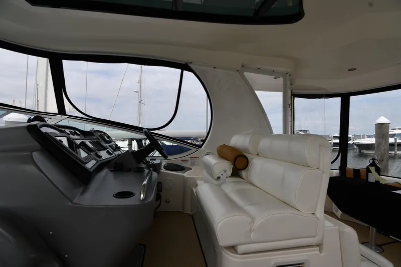 Slide: The Image of 2007 Cruisers Yachts 455 Express Motoryacht interior with helm and white seating. - 17