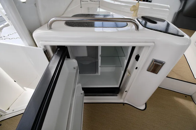 Slide: The Image of 2007 Cruisers Yachts 455 Express Motoryacht interior with open mini fridge and sink. - 23