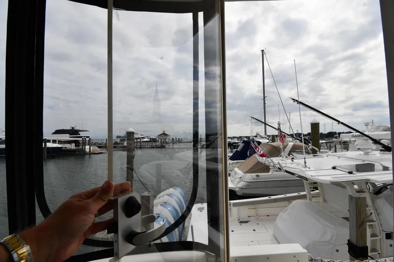 Slide: The Image of Hand opening window on 2007 Cruisers Yachts 455 Express Motoryacht, overlooking marina. - 24