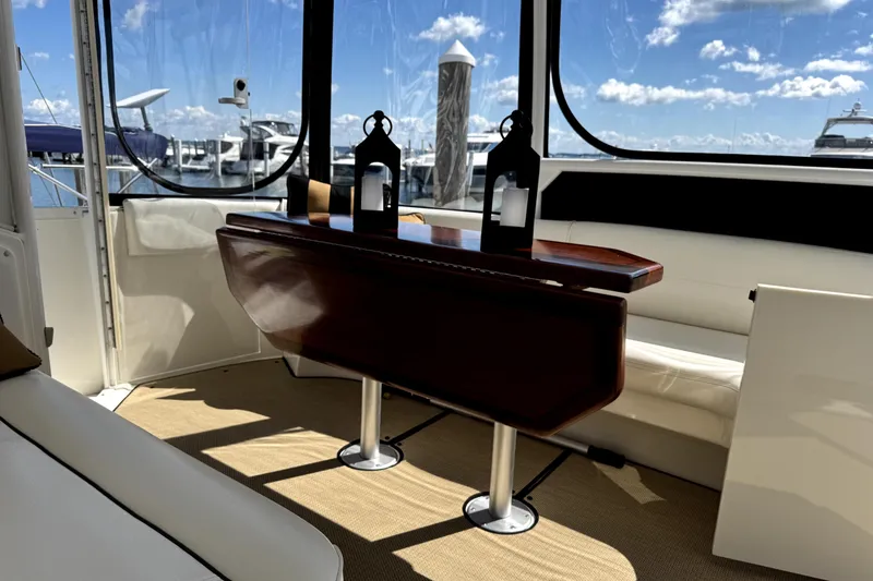 Slide: The Image of 2007 Cruisers Yachts 455 Express Motoryacht interior with elegant seating and wooden table. - 26