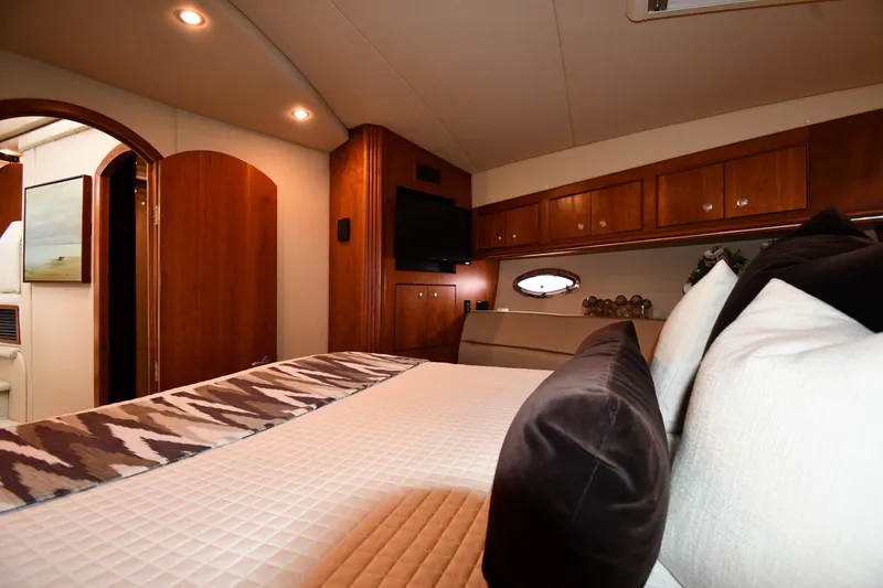 Slide: The Image of Luxurious interior of 2007 Cruisers Yachts 455 Express Motoryacht bedroom with elegant wood finish. - 35