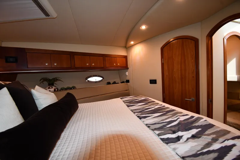 Slide: The Image of Luxurious bedroom interior of 2007 Cruisers Yachts 455 Express Motoryacht, featuring elegant wood finishes. - 36